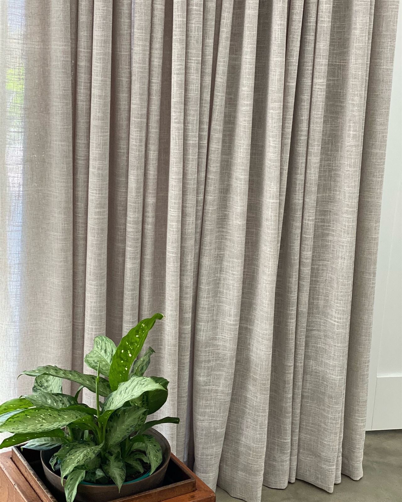 Close-up of a textured linen-look curtain falling to the floor